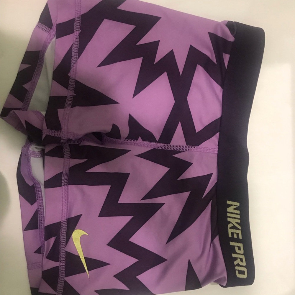 light/dark purple Nike Pros, green lettering